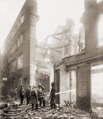 “Firemen hose down the smouldering remains of Cox's Court off Little Britain in the City of London after a Gotha air raid on 7 July 1917” © IWM (HO 77)