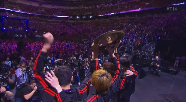 Newbee lift the Aegis, a shield inscribed with the names of winners.